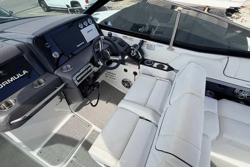 Slide: The Image of Interior of 2022 Formula 330 Crossover Bowrider I/O, featuring sleek dashboard and seating. - 27