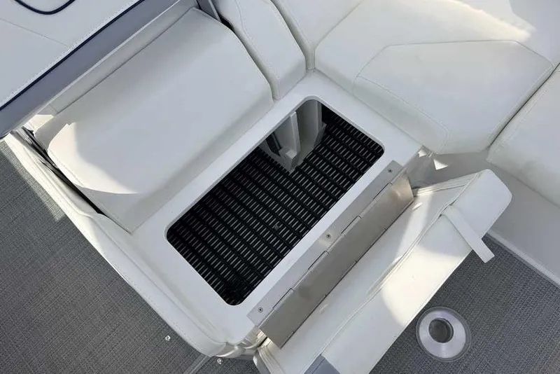 Slide: The Image of 2022 Formula 330 Crossover Bowrider I/O with open storage compartment, featuring white seating. - 22
