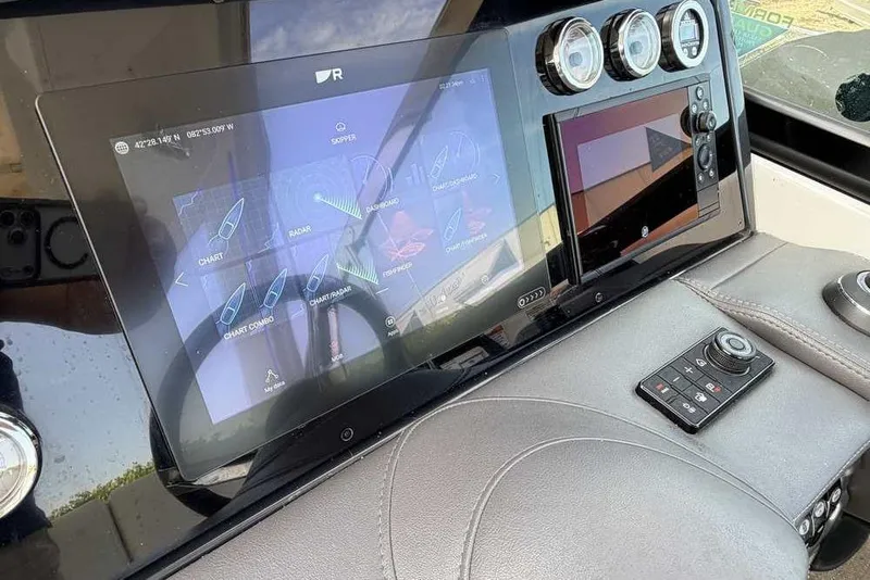 Slide: The Image of Dashboard of 2022 Formula 330 Crossover Bowrider I/O with navigation display and controls. - 29