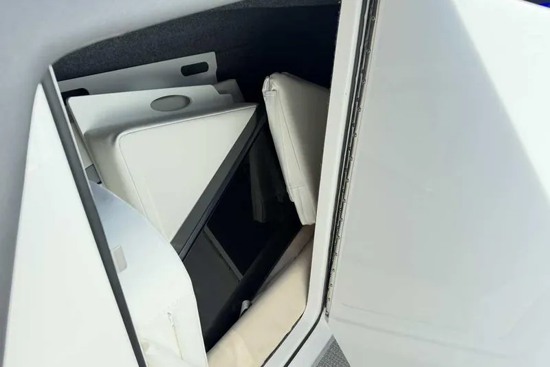Slide: The Image of Storage compartment in 2022 Formula 330 Crossover Bowrider I/O boat, featuring white cushions. - 40