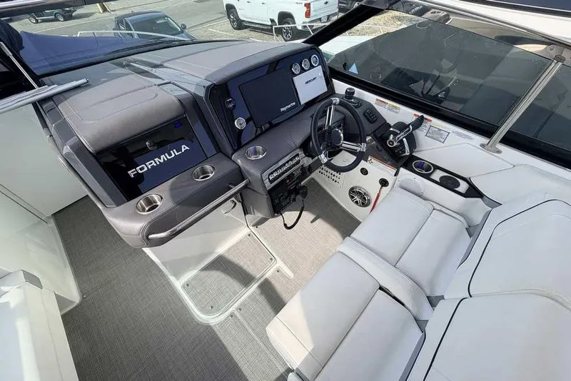 Slide: The Image of 2022 Formula 330 Crossover Bowrider I/O cockpit with modern controls and seating. - 28