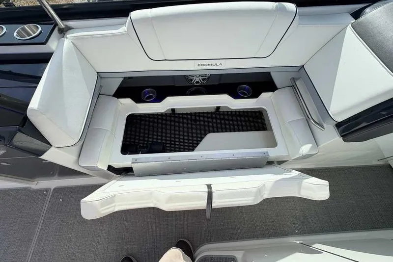 Slide: The Image of 2022 Formula 330 Crossover Bowrider I/O interior seating with storage compartment open. - 19