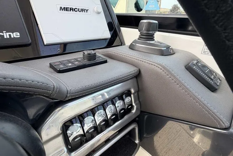 Slide: The Image of 2022 Formula 330 Crossover Bowrider I/O dashboard with Mercury controls and switches. - 33
