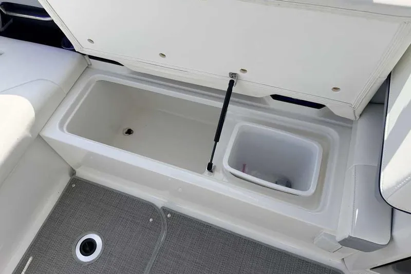 Slide: The Image of 2022 Formula 330 Crossover Bowrider I/O storage compartment with open lid and interior view. - 14