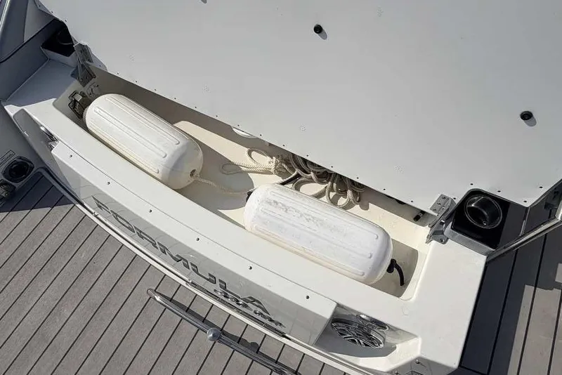 Slide: The Image of Storage compartment of 2022 Formula 330 Crossover Bowrider I/O with fenders and ropes. - 9