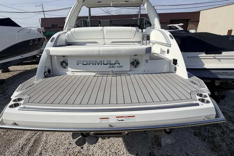 Slide: The Image of 2022 Formula 330 Crossover Bowrider I/O boat with spacious rear deck and seating. - 7