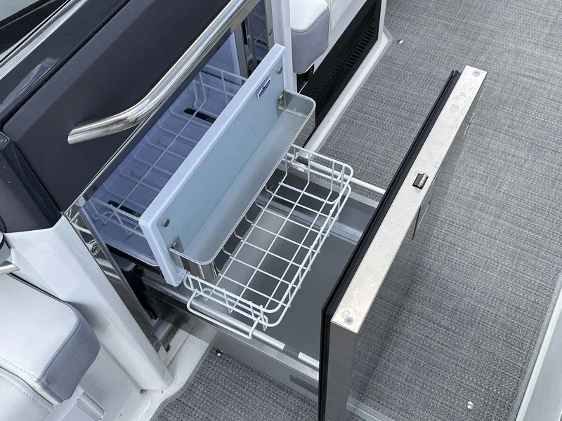 Slide: The Image of An open refrigerator with a pull-out wire basket on a boat. - 17