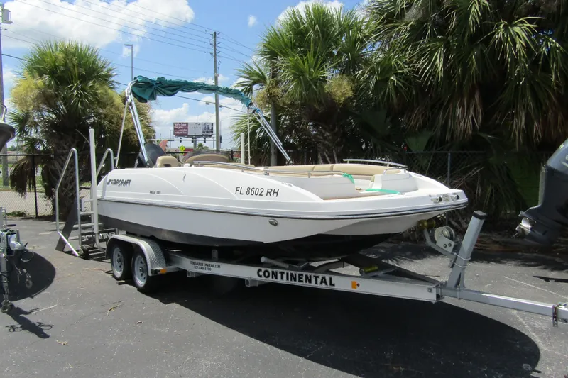 The Image of 2017 SMOKERCRAFT MDX 191 boat on trailer, parked near palm trees. - 1