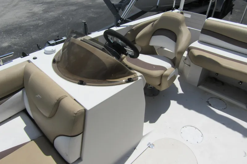 Slide: The Image of 2017 SMOKERCRAFT MDX 191 boat interior with beige seating and steering console. - 7