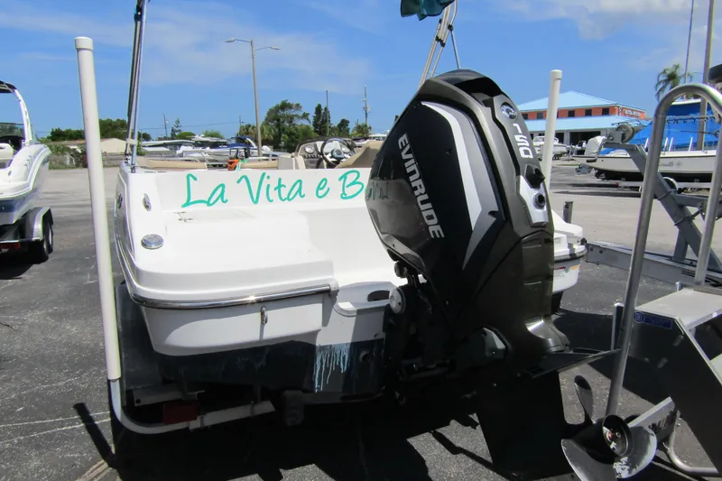 Slide: The Image of 2017 SMOKERCRAFT MDX 191 boat with Evinrude motor, parked outdoors. - 4