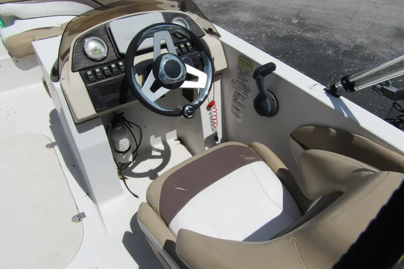 Slide: The Image of 2017 SMOKERCRAFT MDX 191 boat interior with steering wheel and control panel. - 6