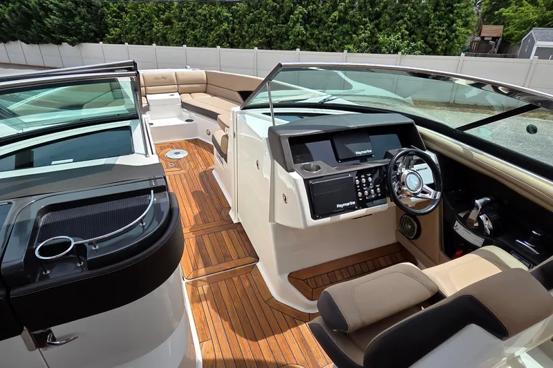 Slide: The Image of Luxurious 2016 Sea Ray SLX 350 boat interior with sleek dashboard and comfortable seating. - 24
