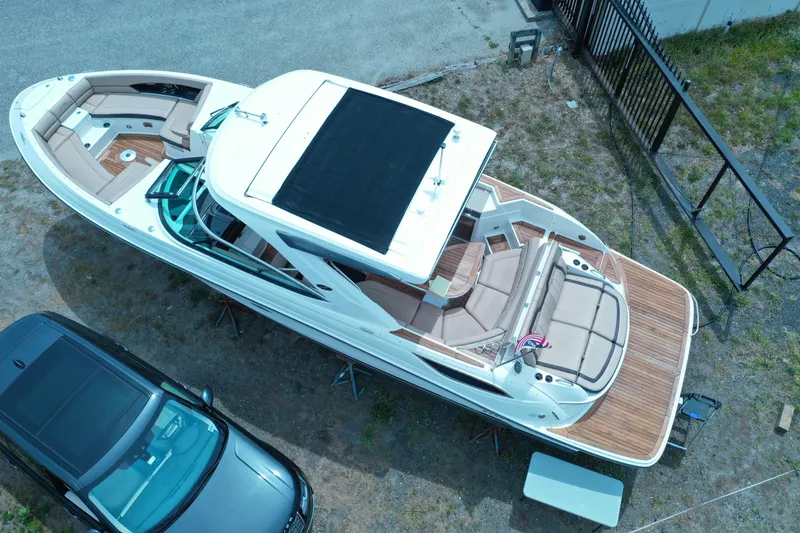 Slide: The Image of Aerial view of a 2016 Sea Ray SLX 350 boat docked beside a car. - 4