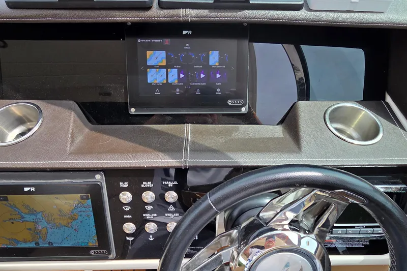 Slide: The Image of Dashboard of a 2016 Sea Ray SLX 350 boat with navigation controls and displays. - 7