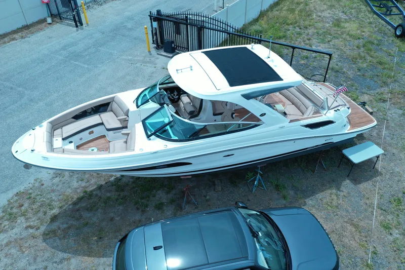 Slide: The Image of 2016 Sea Ray SLX 350 boat on land, aerial view, near parked car. - 26
