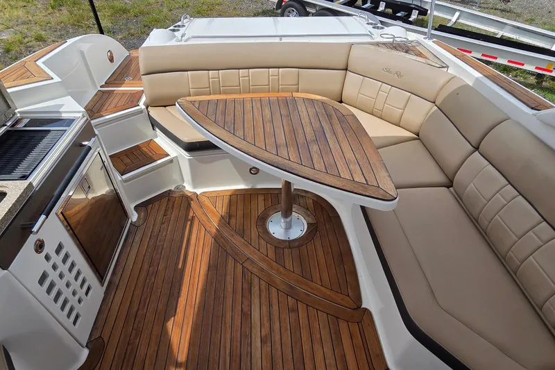 Slide: The Image of Luxurious 2016 Sea Ray SLX 350 boat interior with elegant wood and leather seating. - 12