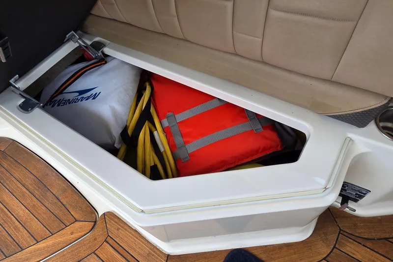 Slide: The Image of Storage compartment on 2016 Sea Ray SLX 350 boat with life jacket and equipment. - 20