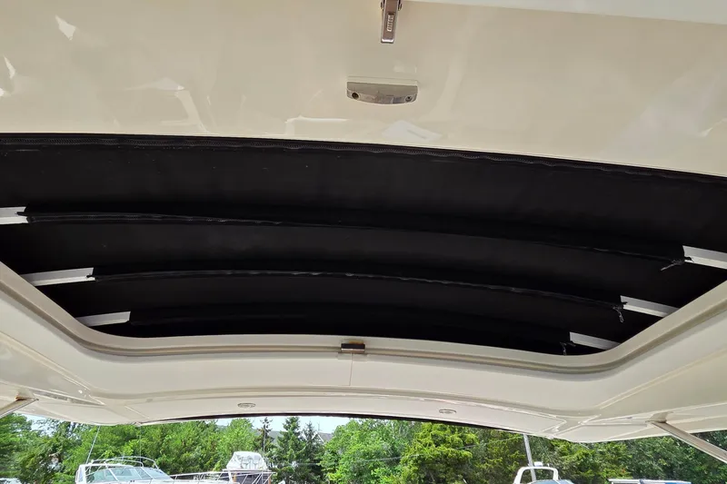 Slide: The Image of 2016 Sea Ray SLX 350 retractable sunroof, showcasing sleek design and functionality. - 11