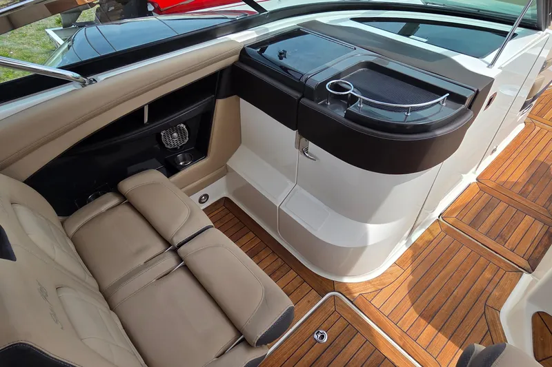 Slide: The Image of Interior of 2016 Sea Ray SLX 350 boat with tan seating and wooden flooring. - 9