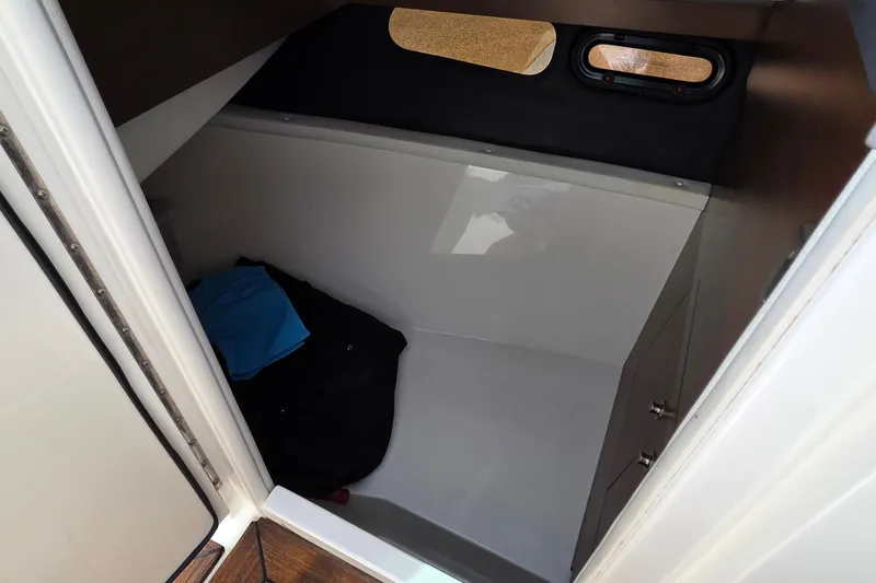 Slide: The Image of Interior cabin of 2016 Sea Ray SLX 350 boat, featuring compact storage space. - 21