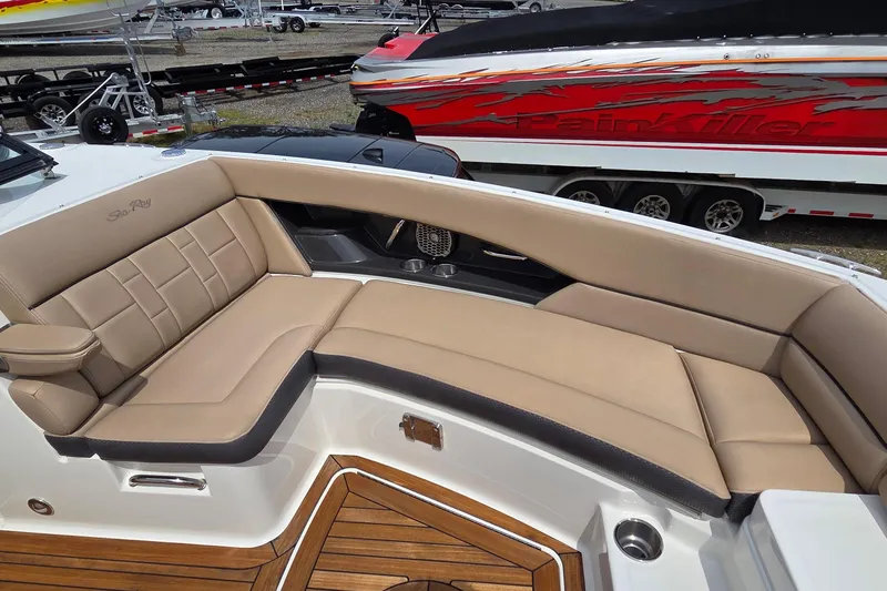 Slide: The Image of Luxurious seating on 2016 Sea Ray SLX 350 boat with tan upholstery and wood accents. - 6