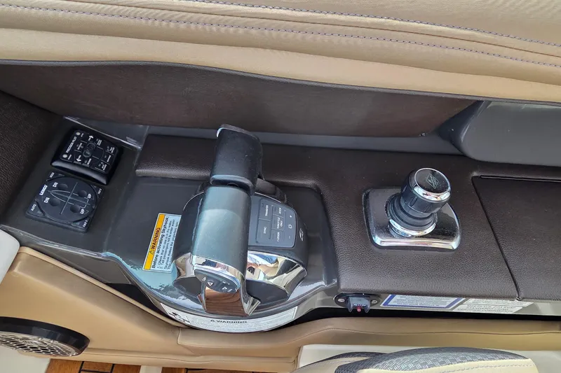 Slide: The Image of Control panel of a 2016 Sea Ray SLX 350 boat, featuring throttle and joystick. - 8
