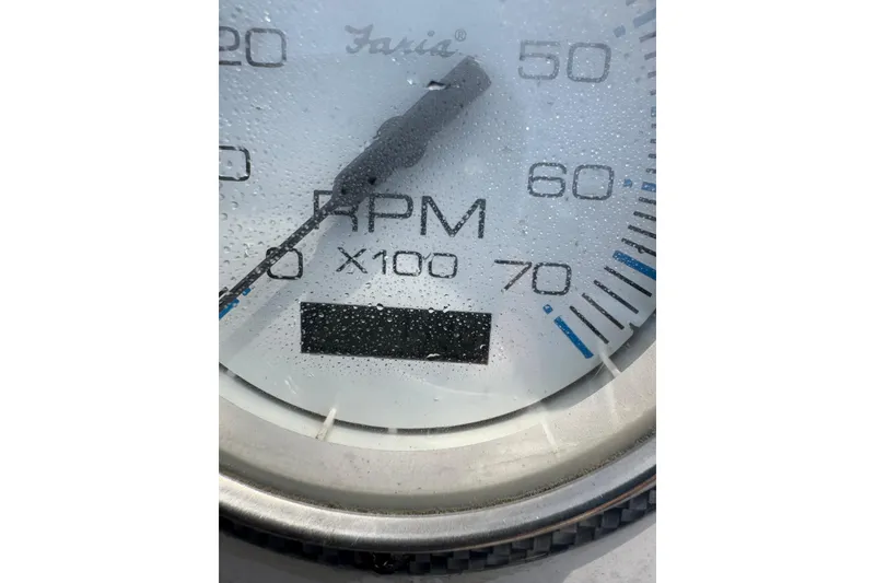 Slide: The Image of Close-up of a Carolina Skiff 198 DLV 2014 RPM gauge with water droplets. - 12