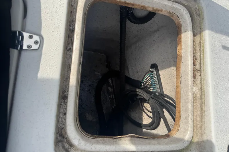 Slide: The Image of Open hatch of a 2014 Carolina Skiff 198 DLV, showing internal wiring and components. - 10