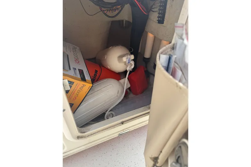 Slide: The Image of Storage compartment in a 2014 Carolina Skiff 198 DLV with boating equipment and accessories. - 14