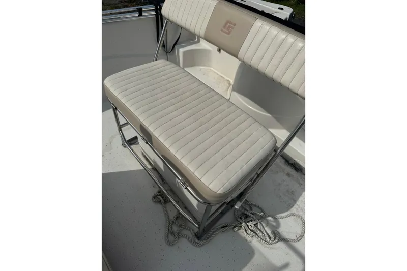Slide: The Image of 2014 Carolina Skiff 198 DLV boat seat with white cushioned upholstery. - 15