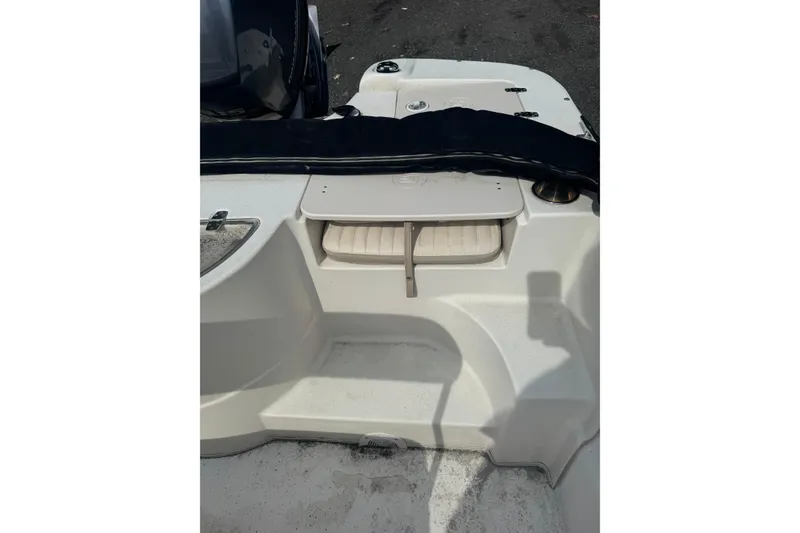 Slide: The Image of 2014 Carolina Skiff 198 DLV boat interior with seating and storage compartments. - 7