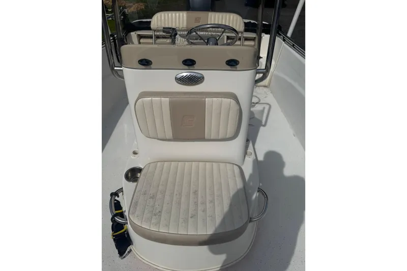 Slide: The Image of 2014 Carolina Skiff 198 DLV boat interior with beige seating and steering console. - 17