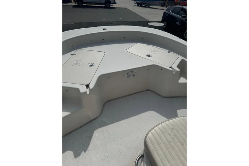 Slide: The Image of 2014 Carolina Skiff 198 DLV boat deck with storage compartments and seating. - 19