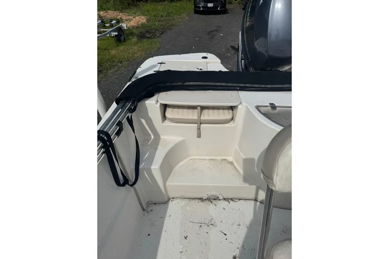 Slide: The Image of 2014 Carolina Skiff 198 DLV boat interior, featuring seating and storage compartments. - 8