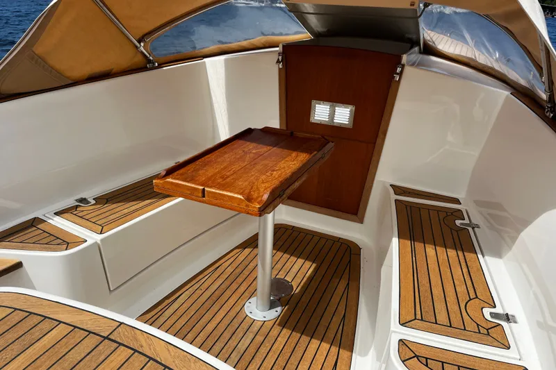 Slide: The Image of Luxurious 2013 AdmiralsTender C28 boat interior with wooden table and seating. - 14