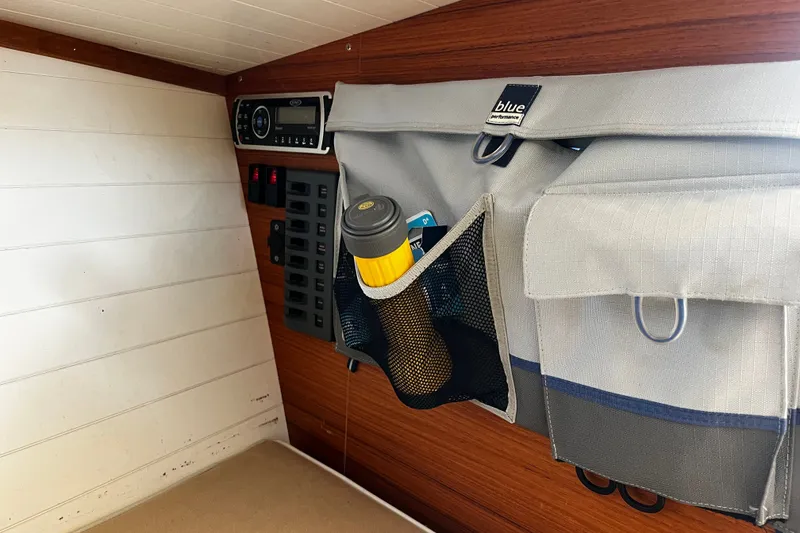Slide: The Image of Interior of 2013 AdmiralsTender C28 boat with storage pockets and control panel. - 21