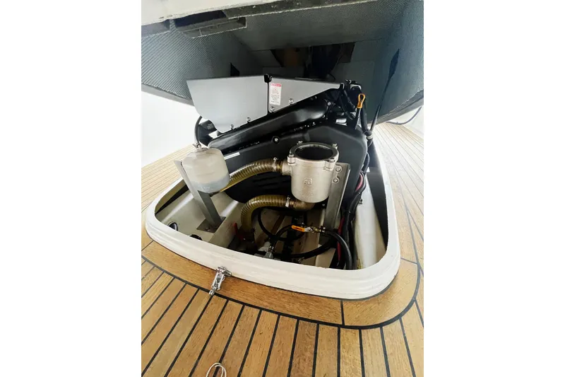 Slide: The Image of Engine compartment of 2013 AdmiralsTender C28 boat with open hatch and visible components. - 16