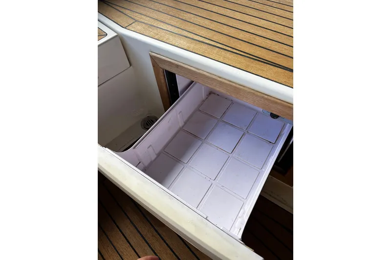 Slide: The Image of Storage compartment on 2013 AdmiralsTender C28 boat with wooden deck. - 18