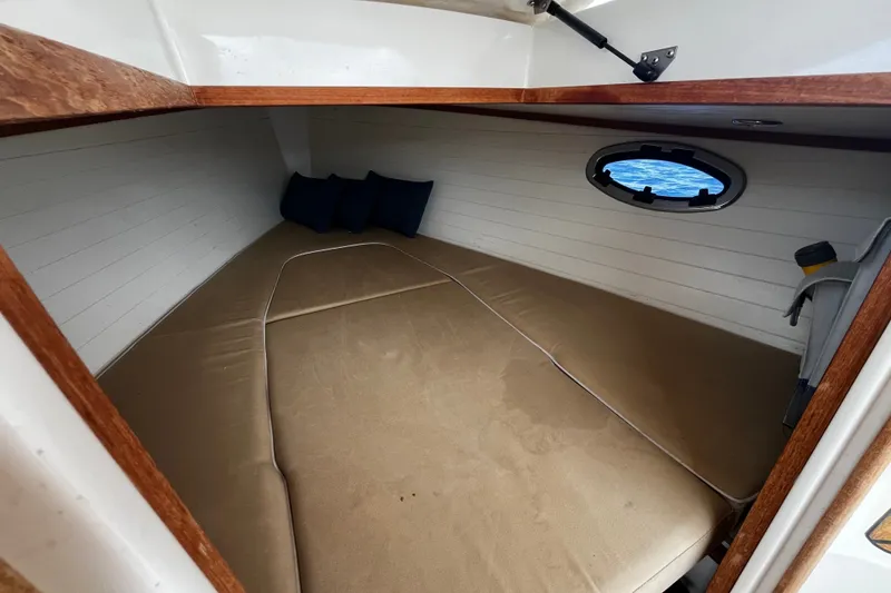 Slide: The Image of Cozy cabin interior of 2013 AdmiralsTender C28 with cushions and porthole view. - 20