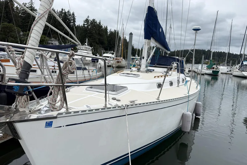 Slide: The Image of Sailboat Tartan 3700, 2000 model, docked in a marina with surrounding boats. - 37