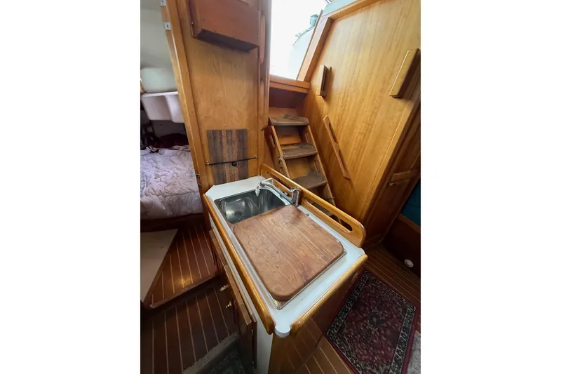 Slide: The Image of Cozy Tartan 3700 yacht interior with wooden cabinetry and compact sink, year 2000 model. - 19