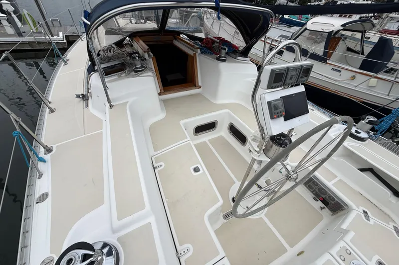 Slide: The Image of Cockpit of a 2000 Tartan 3700 sailboat with steering wheel and navigation instruments. - 4