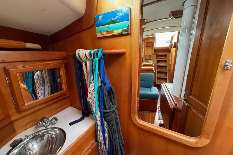 Slide: The Image of Interior of 2000 Tartan 3700 sailboat with wooden cabinetry and nautical ropes. - 15