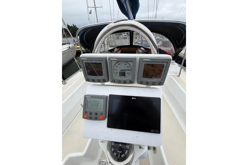 Slide: The Image of Cockpit of 2000 Tartan 3700 sailboat with navigation instruments and steering wheel. - 27