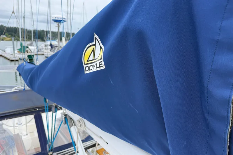 Slide: The Image of Blue sail cover on Tartan 3700 yacht, featuring Doyle logo, docked in marina. - 44