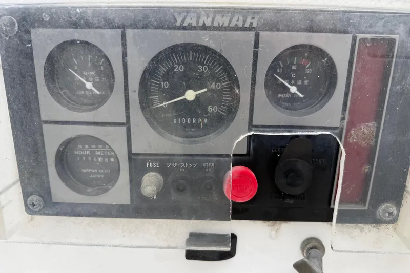 Slide: The Image of Yanmar engine control panel with gauges and switches on a 2000 Tartan 3700. - 32