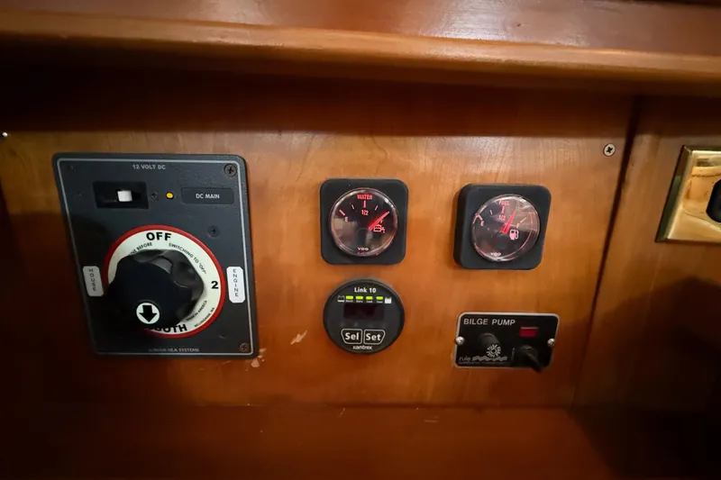 Slide: The Image of Control panel of a 2000 Tartan 3700 yacht with gauges and switches. - 30