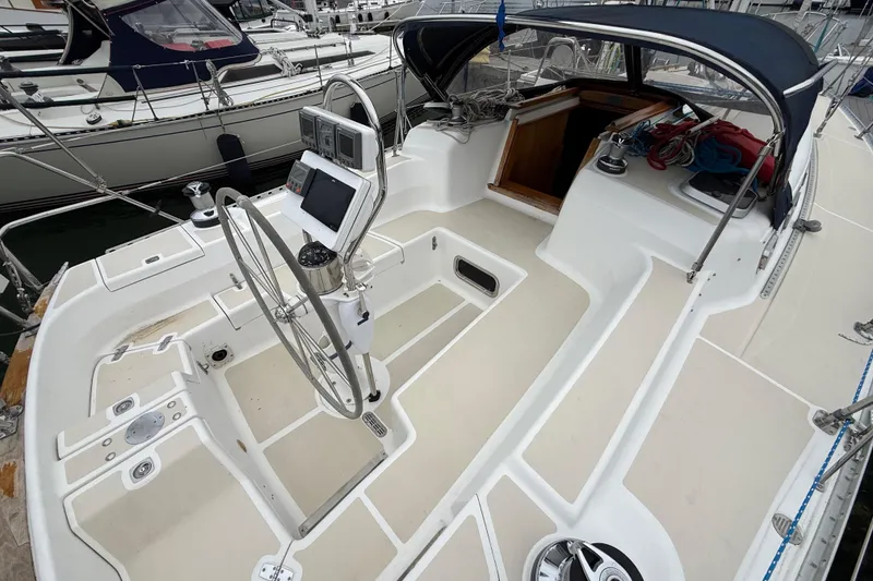 Slide: The Image of Cockpit of a 2000 Tartan 3700 sailboat with steering wheel and navigation equipment. - 43