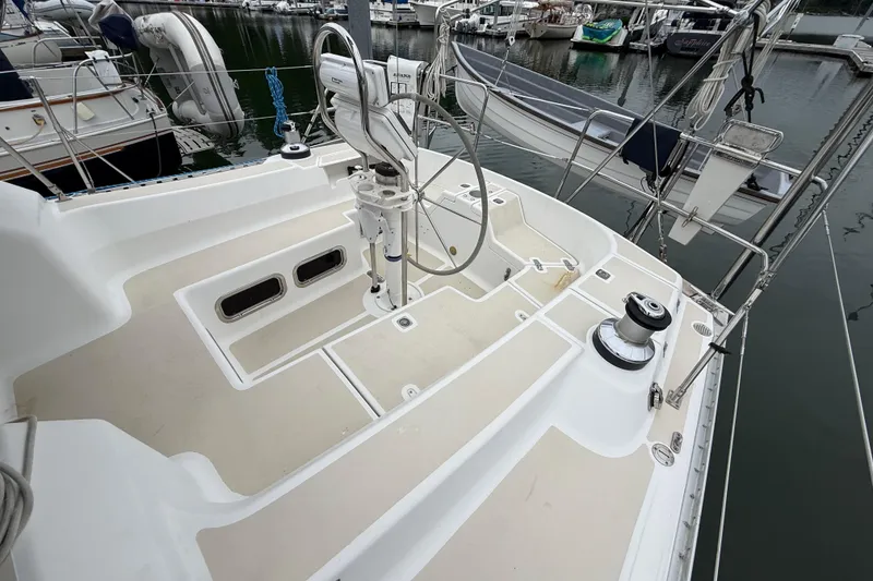 Slide: The Image of Tartan 3700 sailboat cockpit, 2000 model, docked at marina with visible winches and rigging. - 3