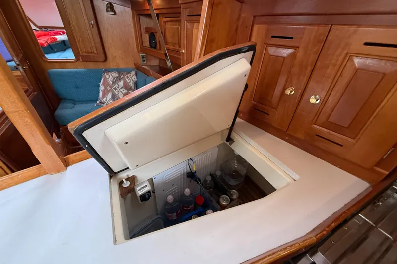 Slide: The Image of Interior of a 2000 Tartan 3700 sailboat with open storage compartment. - 45